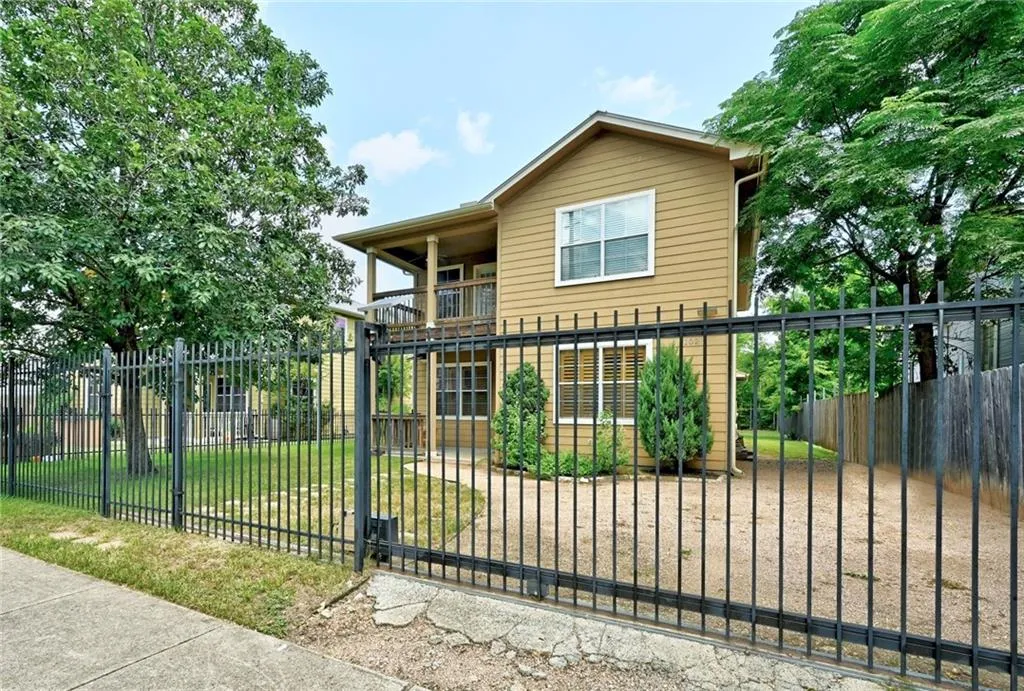 a view of a wrought iron fences in front of house