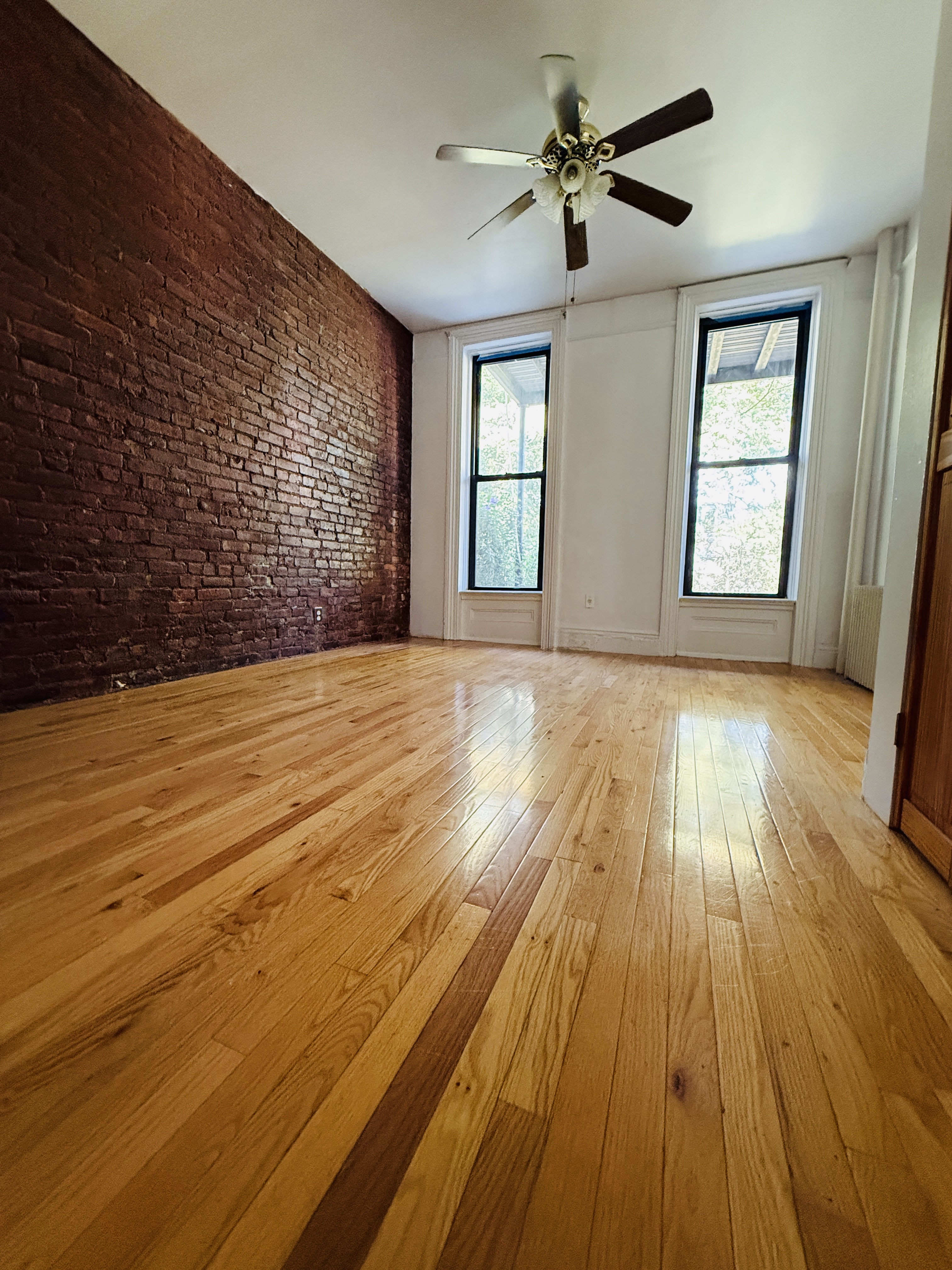 476 7th Avenue, Unit 1 Brooklyn, NY 11215 - Photo 1 of 6 a view of empty room with wooden floor and fan