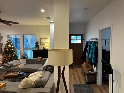 a living room with furniture and a lamp