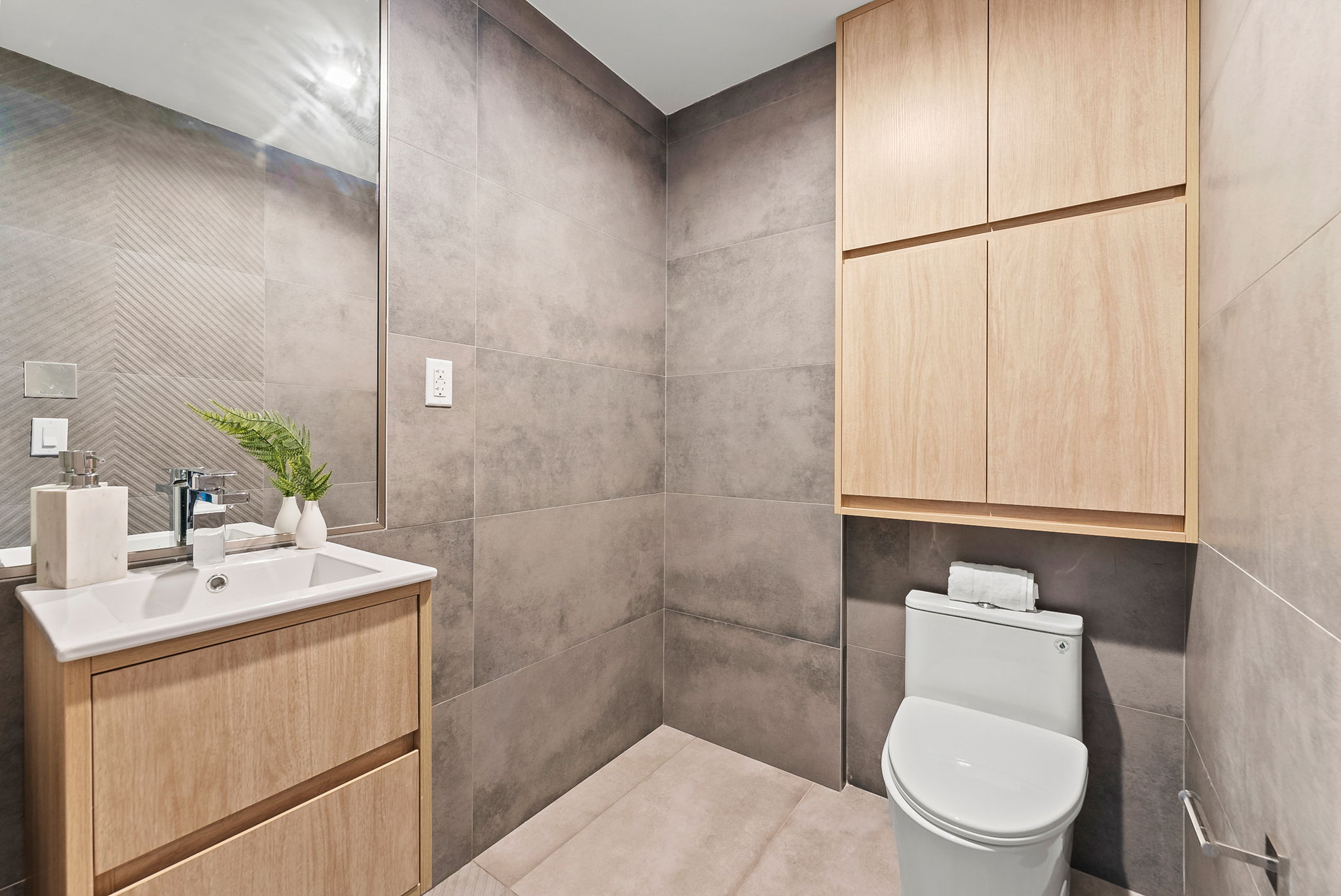 553 West 182nd Street, Unit 5R Manhattan, NY 10033 - Photo 7 of 12 a bathroom with a toilet a sink and mirror