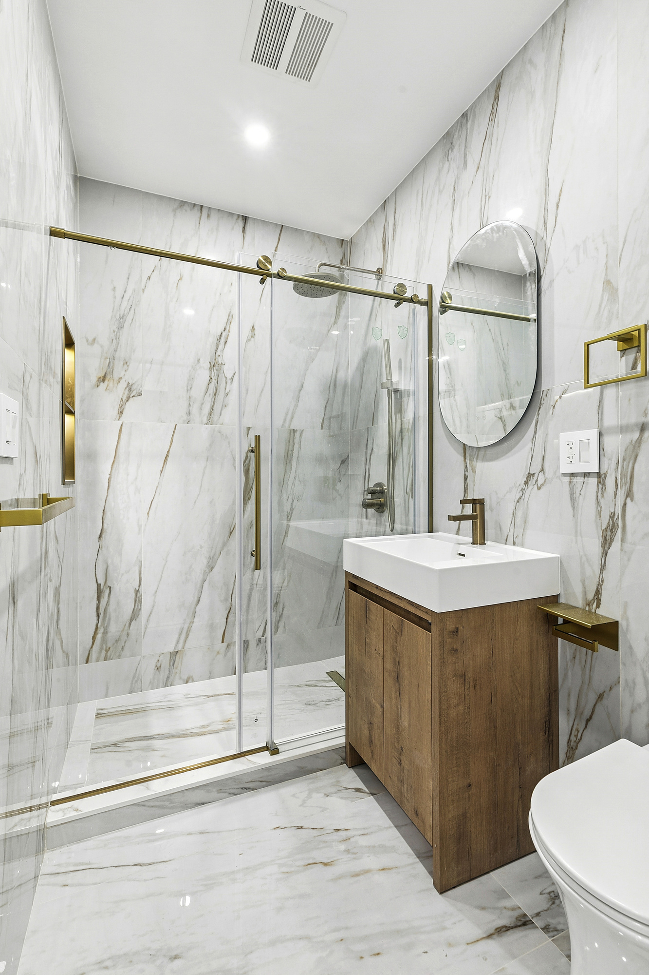 472 Bergen Street, Unit 2R Brooklyn, NY 11217 - Photo 7 of 9 a bathroom with a sink mirror vanity and toilet