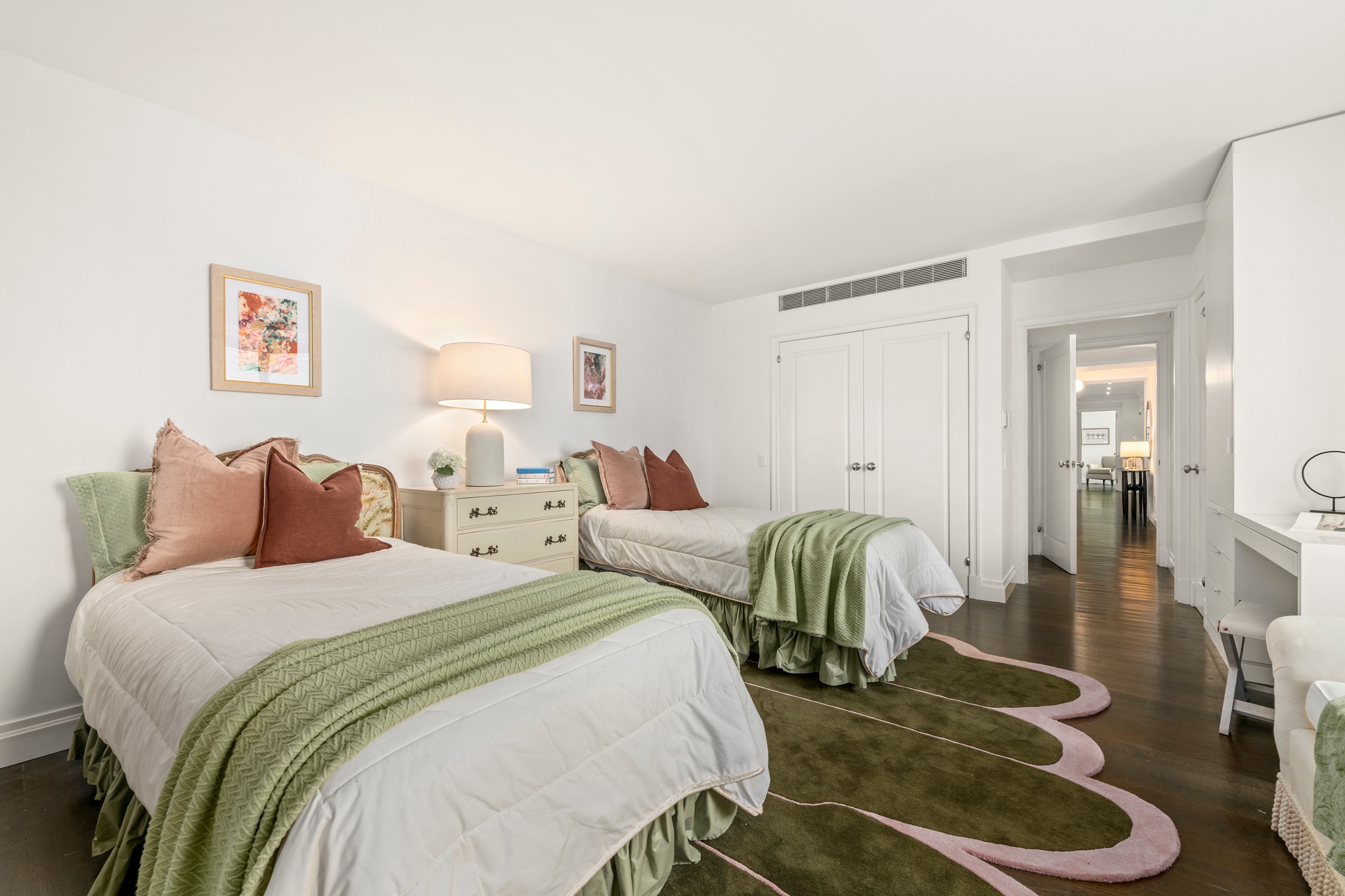 200 East 66th Street, Unit D1205 Manhattan, NY 10065 - Photo 12 of 33 a bedroom with two beds and painting on the wall