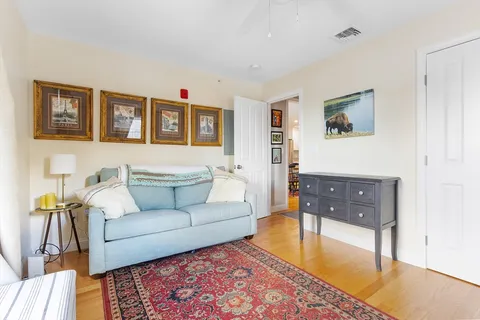 a living room with furniture and painting on the wall