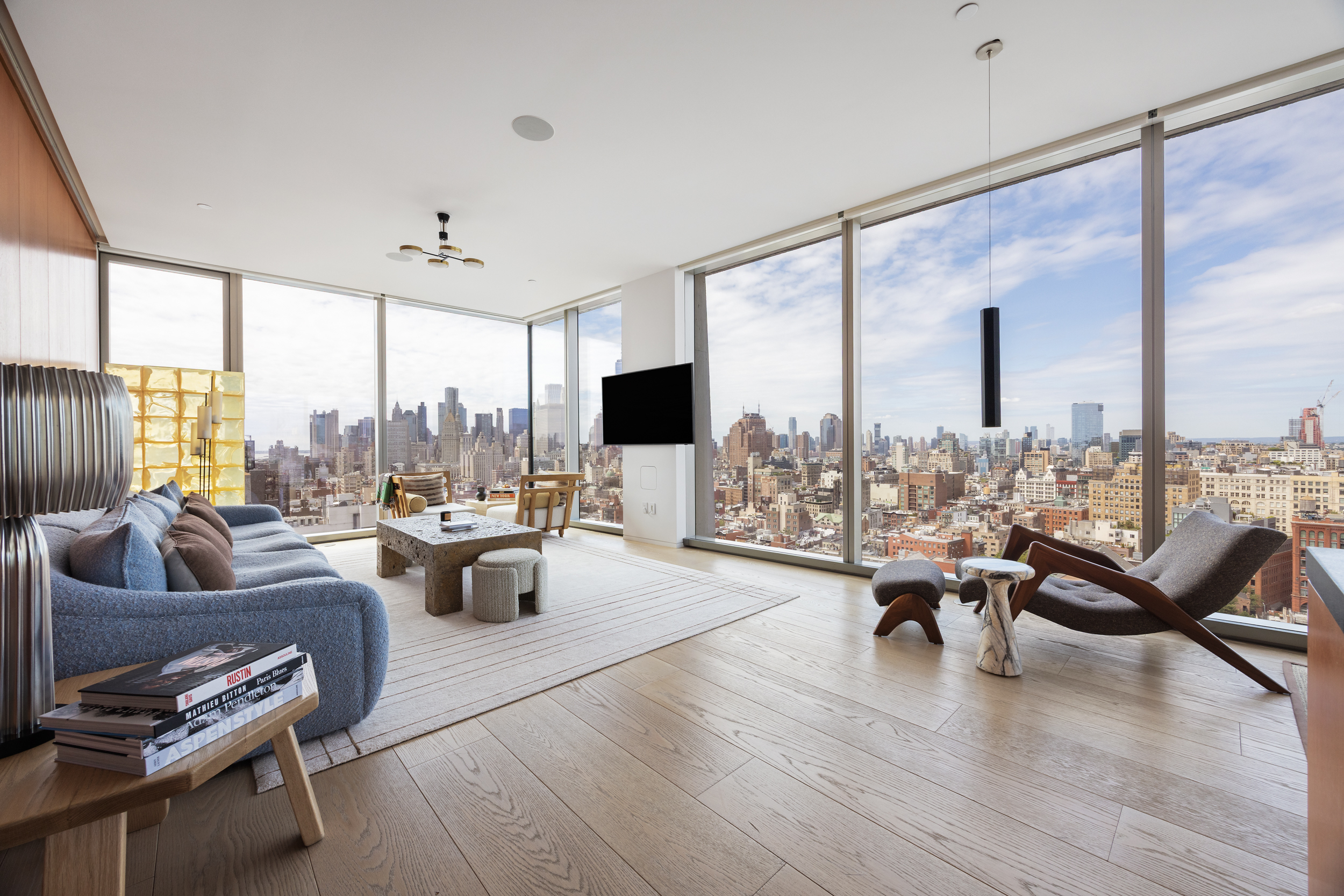 a living room with furniture large window and a flat screen tv