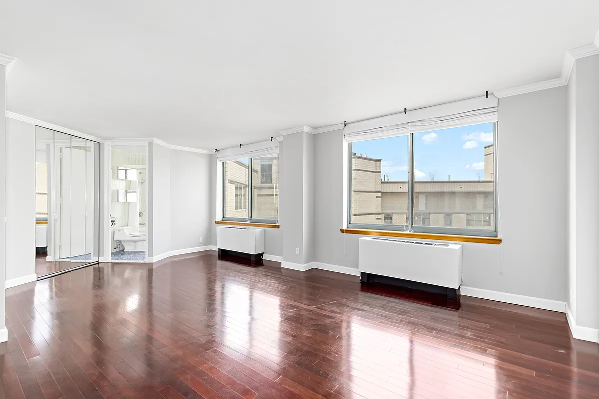 21 South End Avenue, Unit PH2BB Manhattan, NY 10280 - Photo 1 of 5 an empty room with wooden floor and windows