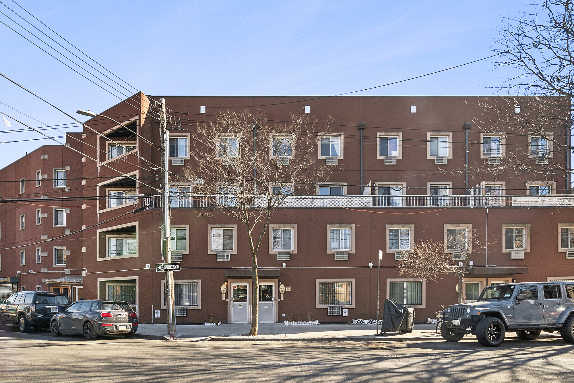 21-08 Butler Avenue, Unit J2 Queens, NY 11385 - Photo 12 of 14 a city street lined with buildings and a street