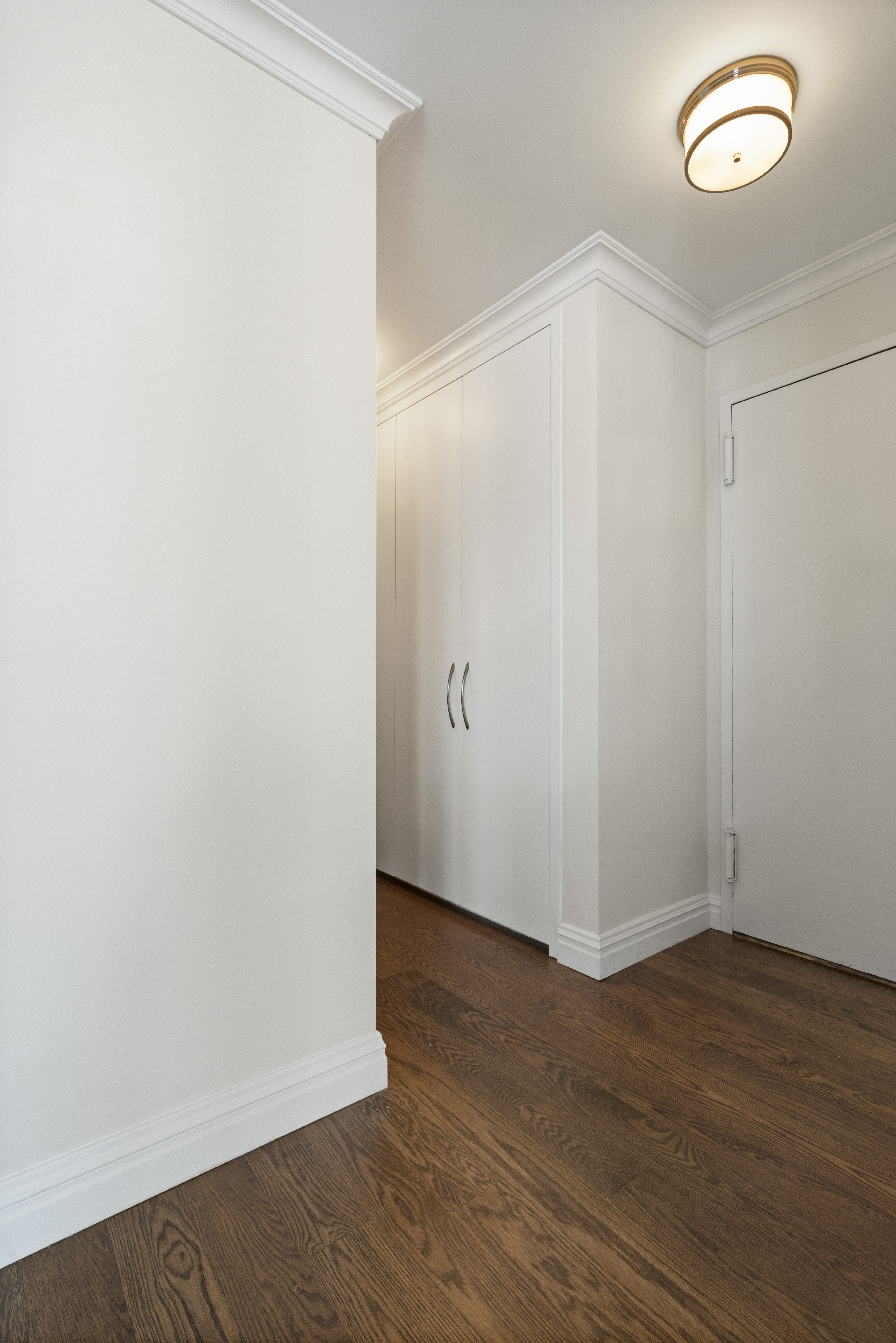 555 Main Street, Unit 411 Manhattan, NY 10044 - Photo 4 of 6 a view of an empty room with wooden floor