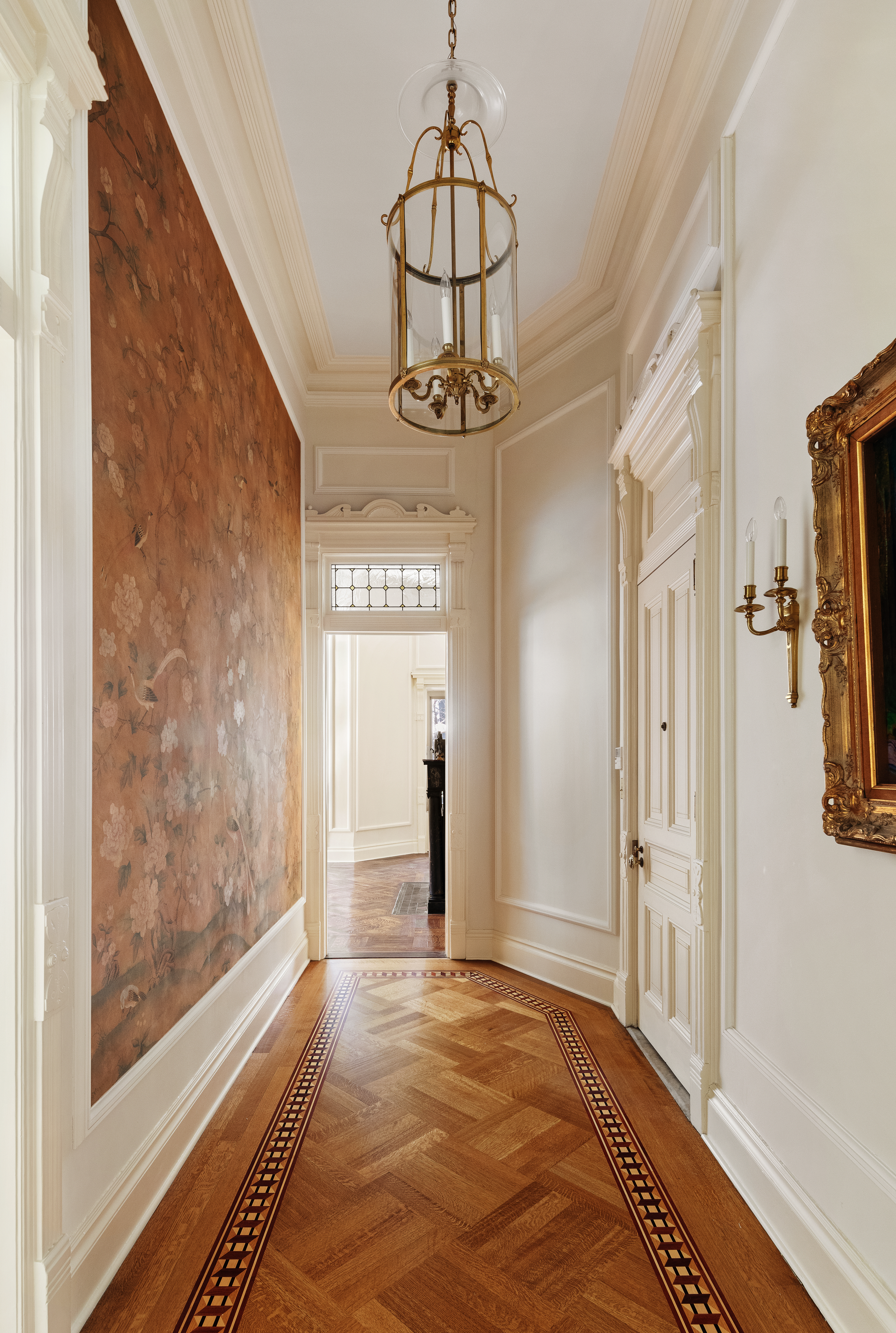 34 Gramercy Park East, Unit MAF Manhattan, NY 10010 - Photo 4 of 17 a view of a hallway with wooden floor and a chandelier