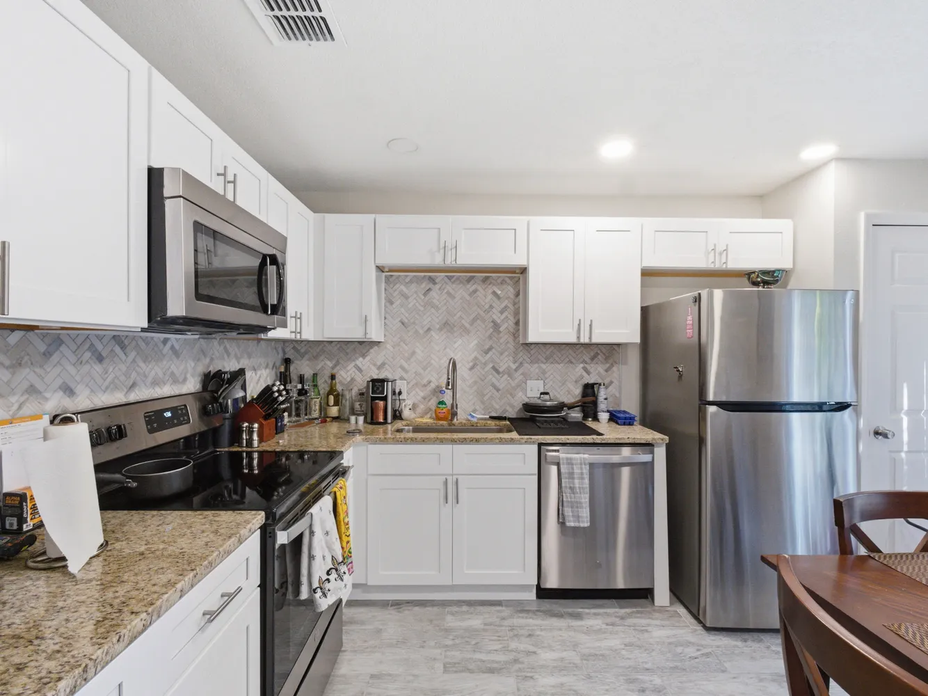 a kitchen with a sink a stove a refrigerator and cabinets