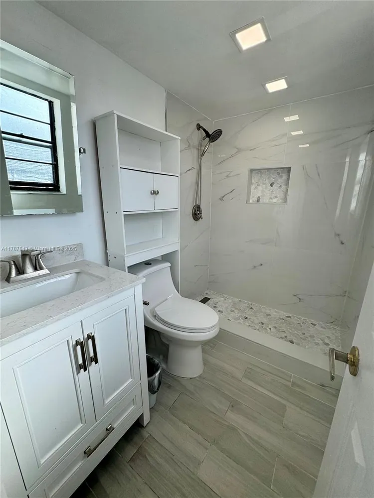 a view of a lake with houses in the back