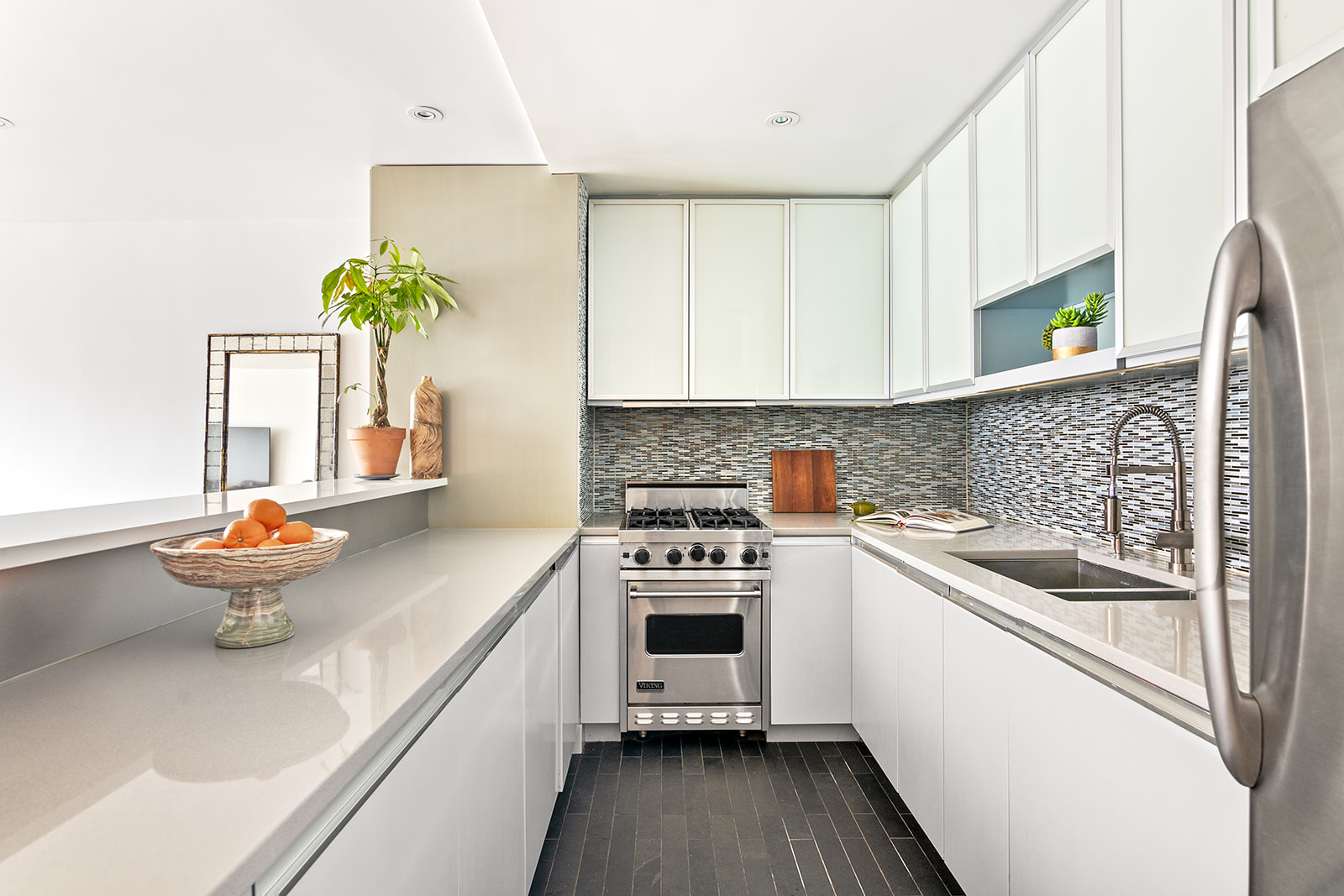 447 West 45th Street, Unit 5A Manhattan, NY 10036 - Photo 3 of 12 a kitchen with stainless steel appliances a sink a stove and a refrigerator