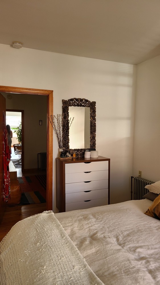 562 Fairview Avenue, Unit 1R Queens, NY 11385 - Photo 9 of 11 a bedroom with a bed and a flat screen tv