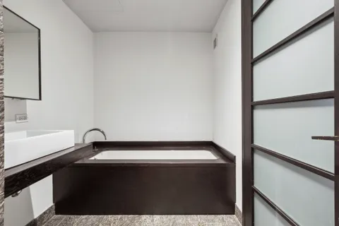 a view of a patio with a table and chairs and potted plants