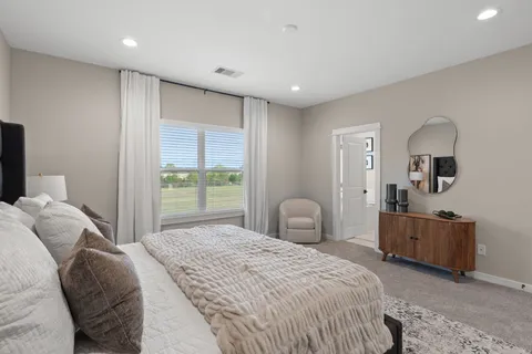 a bedroom with a bed and a dresser