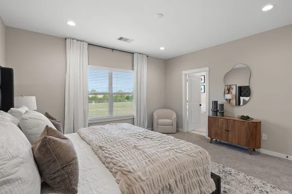 a bedroom with a bed and a dresser