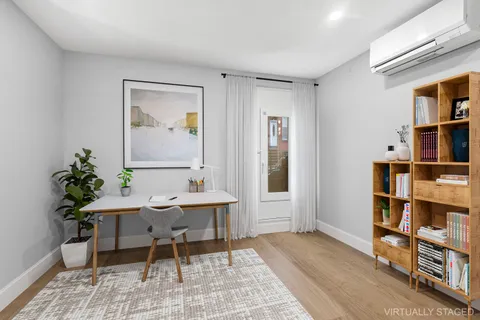 a workspace with furniture window and wooden floor