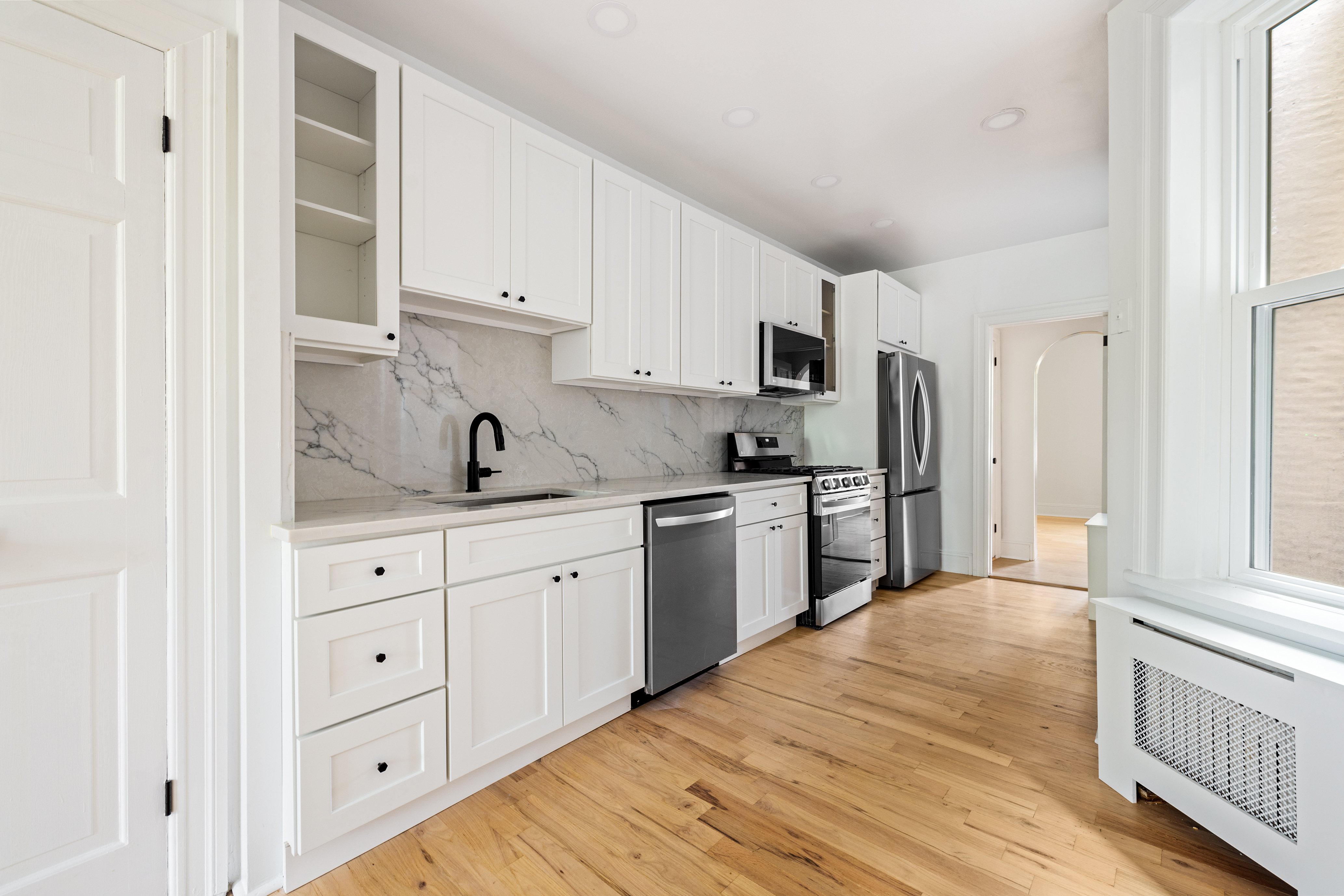 456 Prospect Avenue, Unit 3R Brooklyn, NY 11215 - Photo 4 of 16 a kitchen with granite countertop white cabinets and stainless steel appliances
