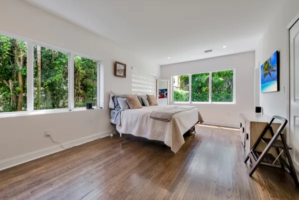 a bed room with a bed and a chair