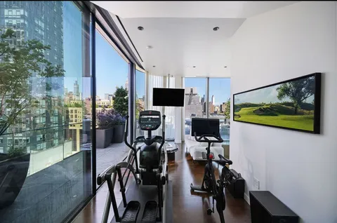 a view of a dining room with furniture and a flat screen tv