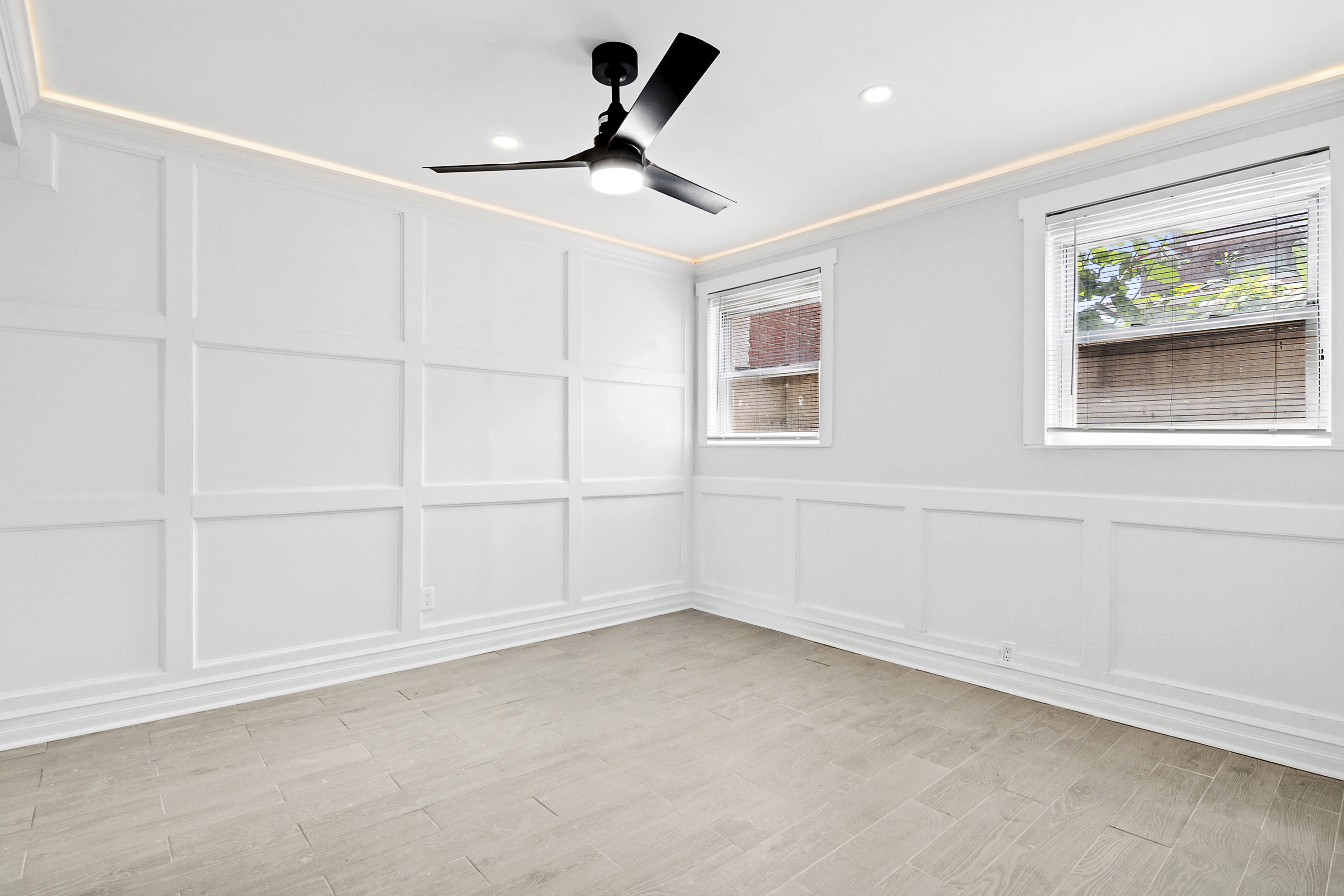 58-07 83rd Place, Unit 1 Queens, NY 11379 - Photo 4 of 5 wooden floor in an empty room with a window