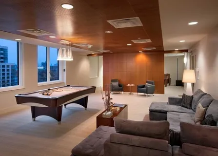 a living room with furniture a table and kitchen view