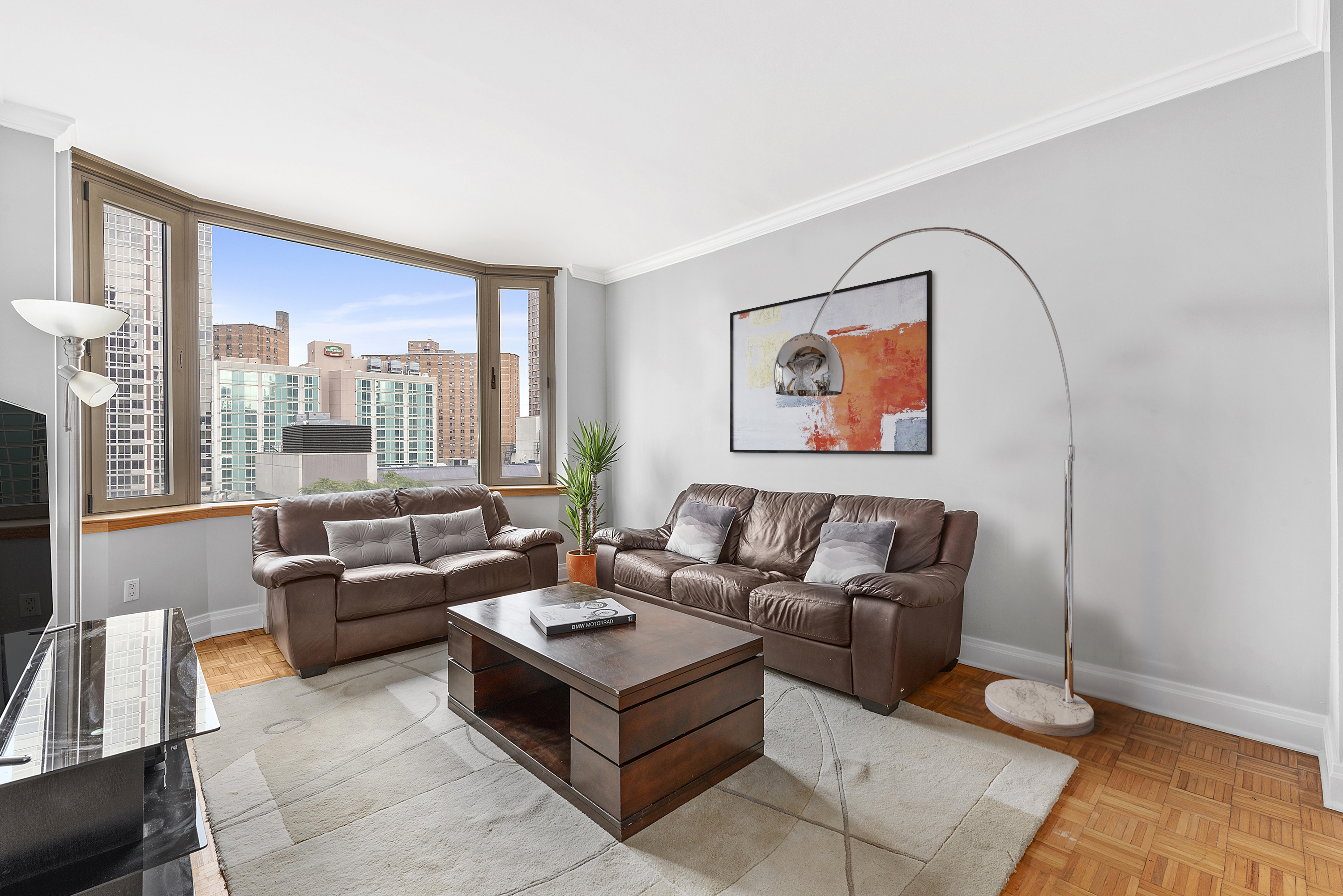 400 East 90th Street, Unit 8E Manhattan, NY 10128 - Photo 1 of 6 a living room with furniture and a large window