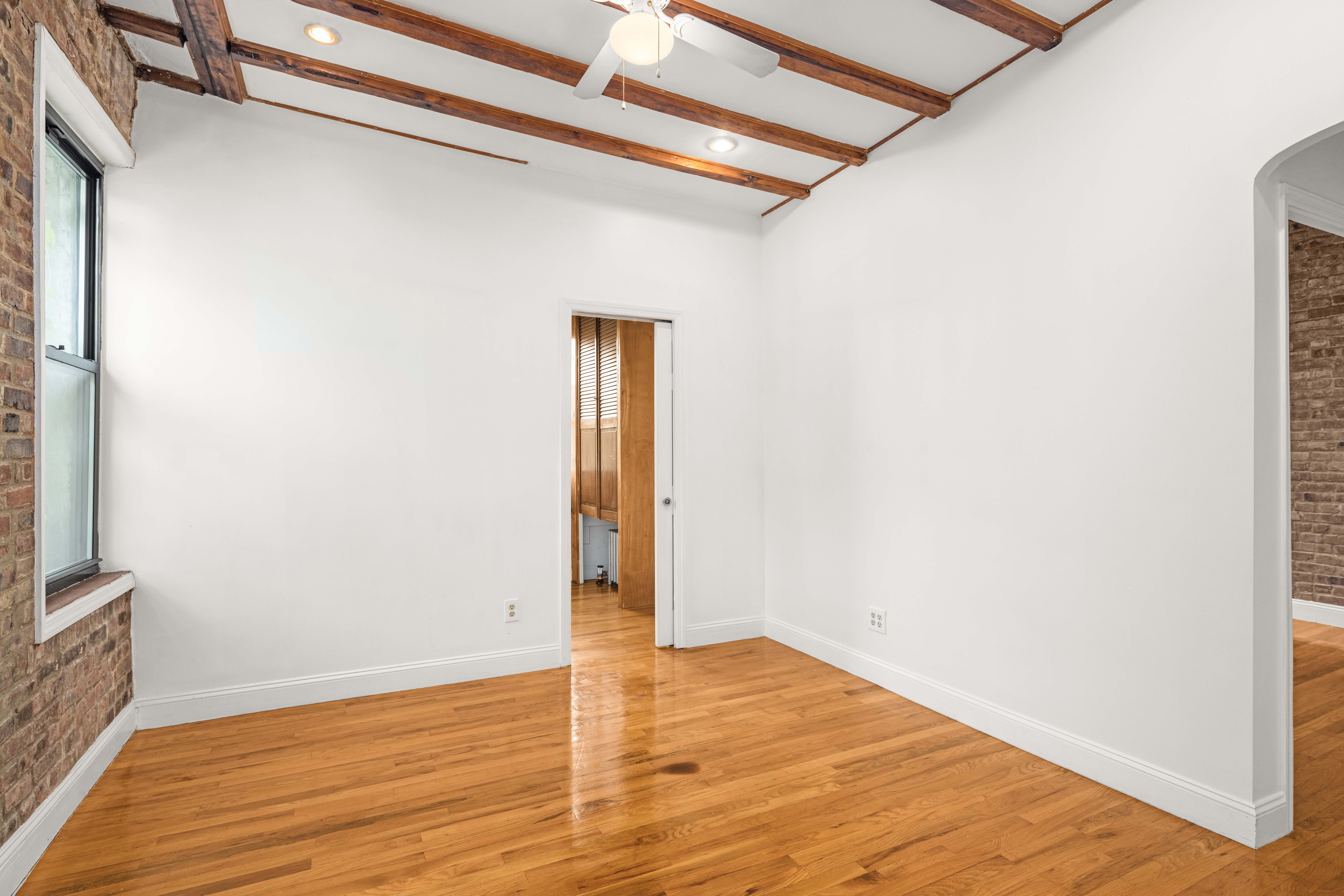 120 Suffolk Street, Unit 5B Manhattan, NY 10002 - Photo 7 of 14 a view of empty room with wooden floor