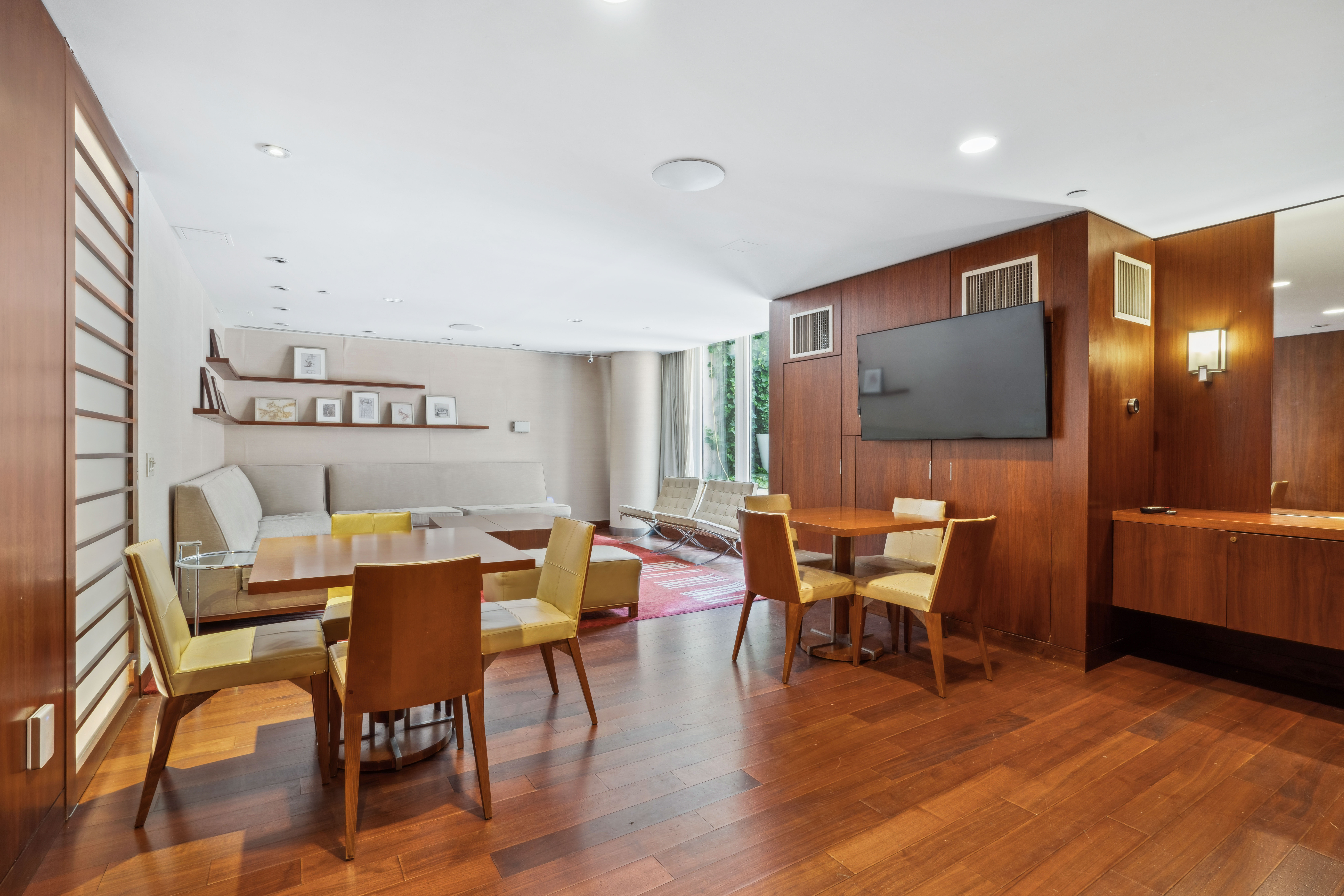 250 East 53rd Street, Unit 1402 Manhattan, NY 10022 - Photo 10 of 13 a view of a dining room with furniture and wooden floor