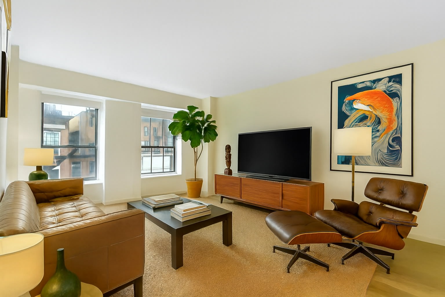 171 West 131st Street, Unit 603 Manhattan, NY 10027 - Photo 1 of 7 a living room with furniture and a flat screen tv