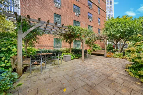 a view of a patio with table and chairs and potted plants