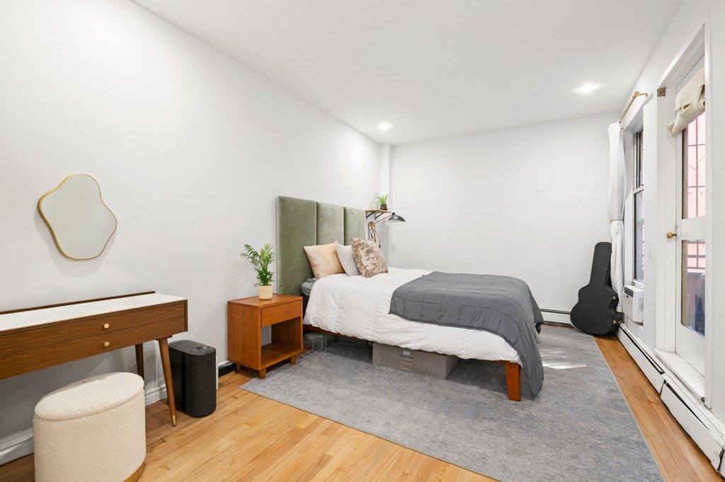 120 Manhattan Avenue, Unit 2A Manhattan, NY 10025 - Photo 4 of 10 a bedroom with a bed and wooden floor