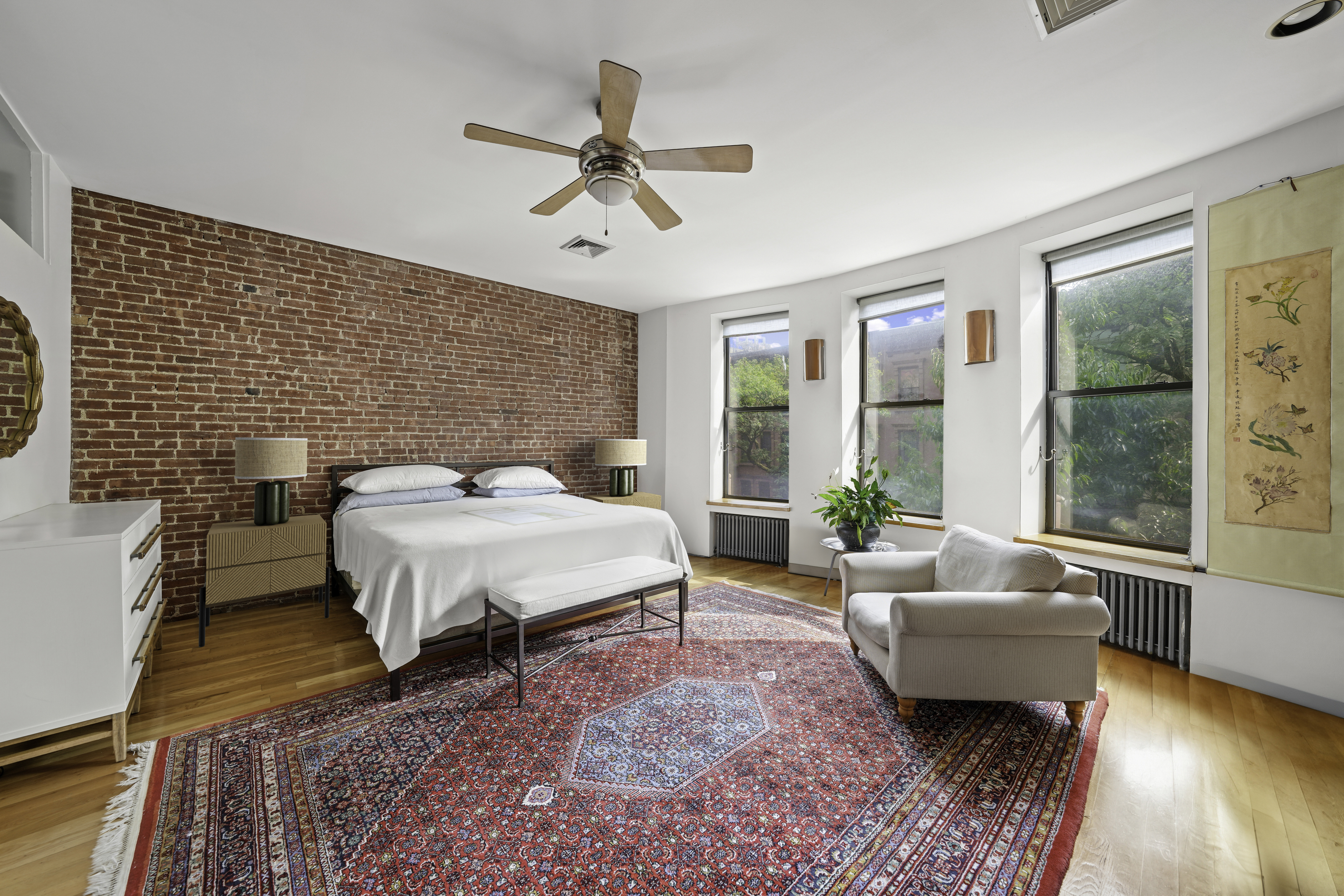 109 West 118th Street Manhattan, NY 10026 - Photo 10 of 31 a spacious bedroom with a bed a couch and a large window