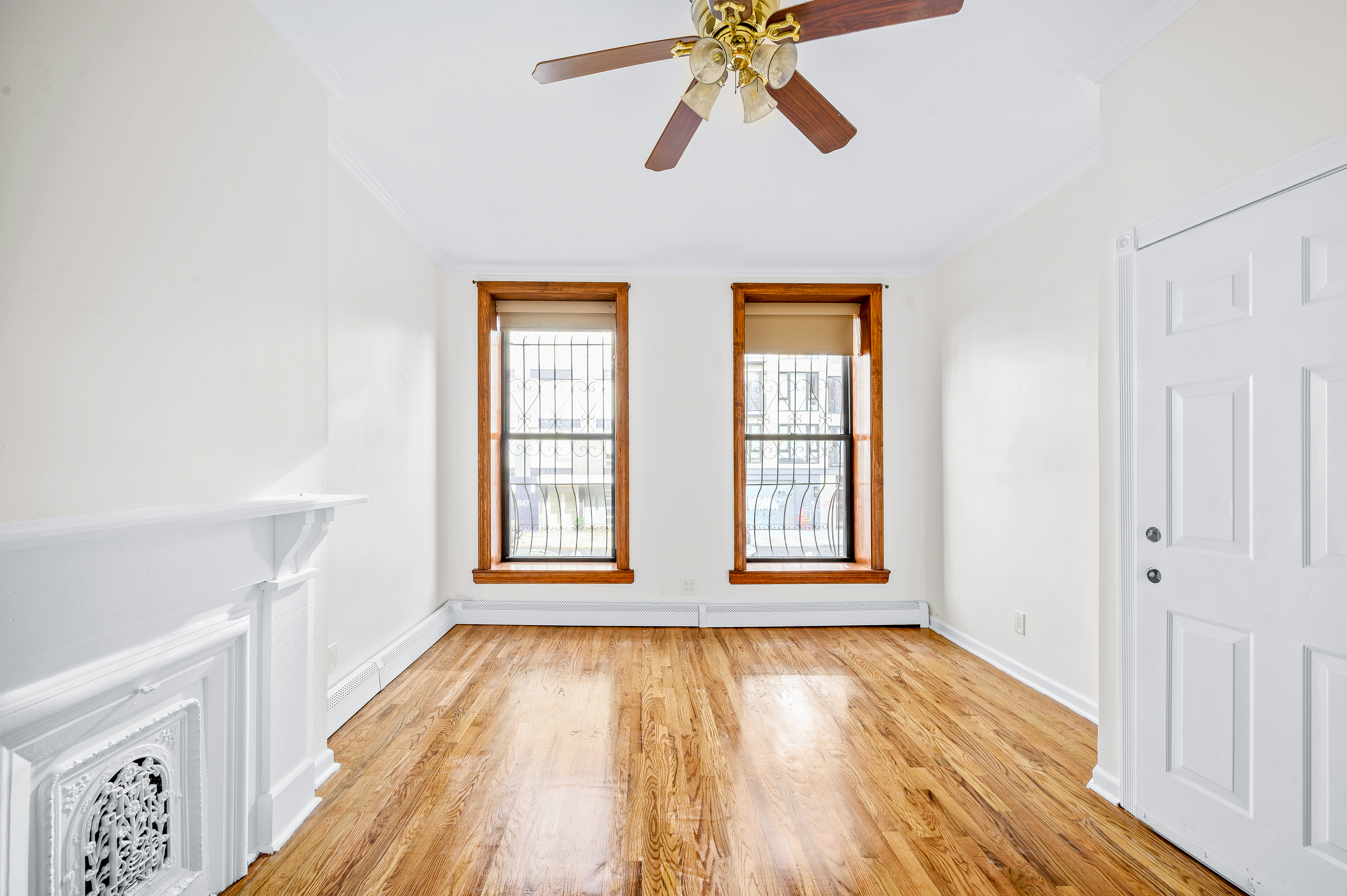 808 Lexington Avenue, Unit 1 Brooklyn, NY 11221 - Photo 4 of 8 a view of an empty room with wooden floor and a window