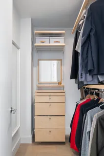 a view of walk in closet with clothes and shoes