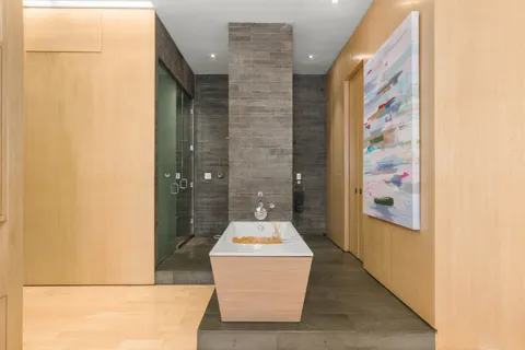 a bathroom with a tub and mirror
