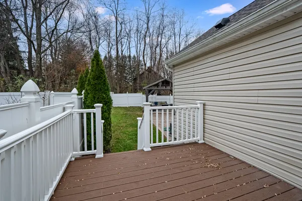 a view of a deck with wooden floor and fence and a floor to ceiling window