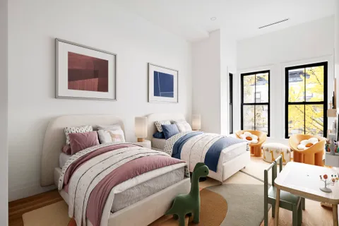 a bedroom with two beds and a large window