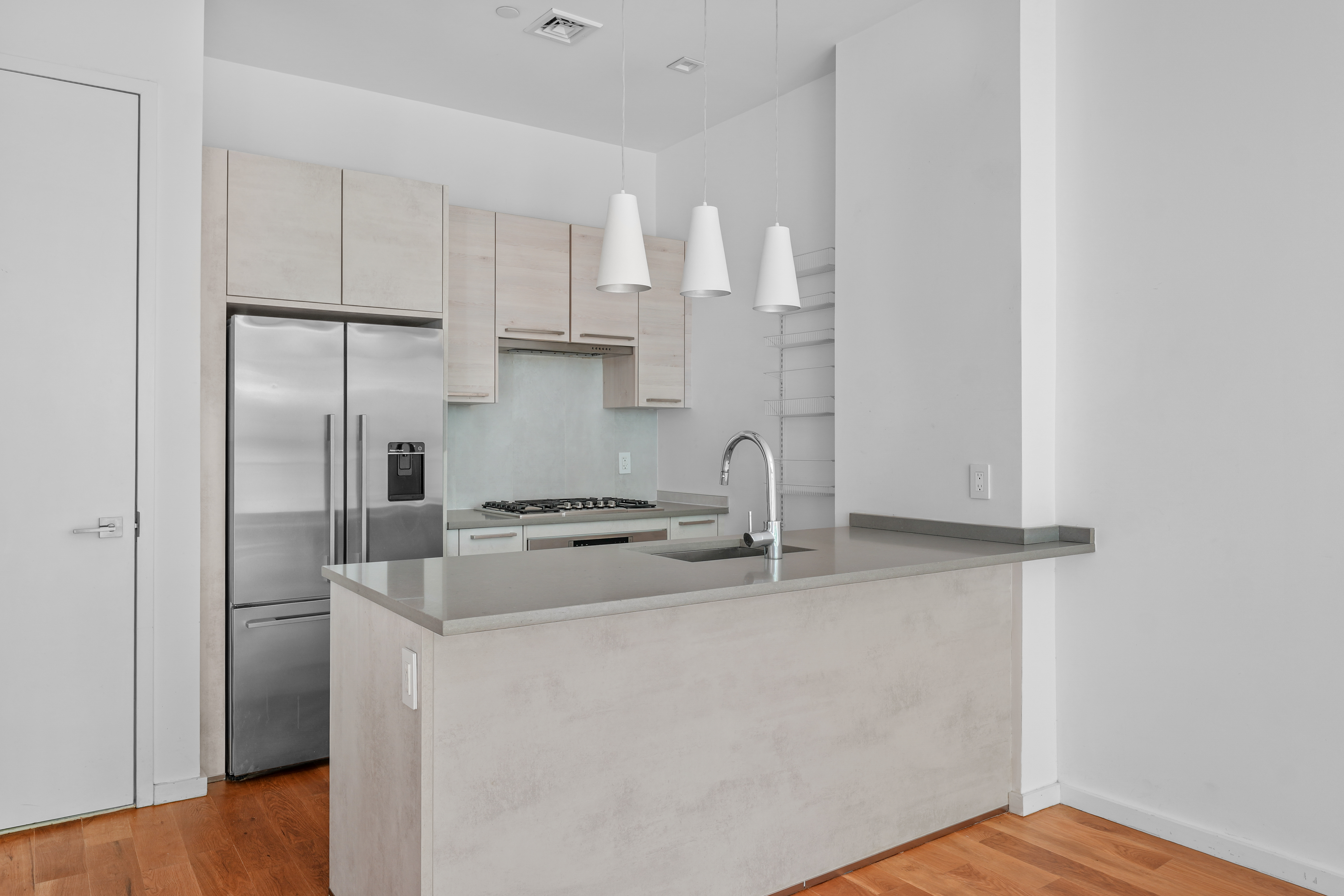 1143 Lafayette Avenue, Unit 4B Brooklyn, NY 11221 - Photo 2 of 9 a kitchen with stainless steel appliances granite countertop a refrigerator sink and white cabinets