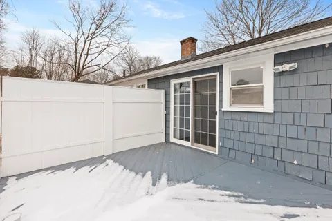a view of a house with a snow in the yard