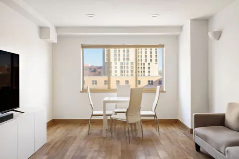 a view of a livingroom with furniture and a window