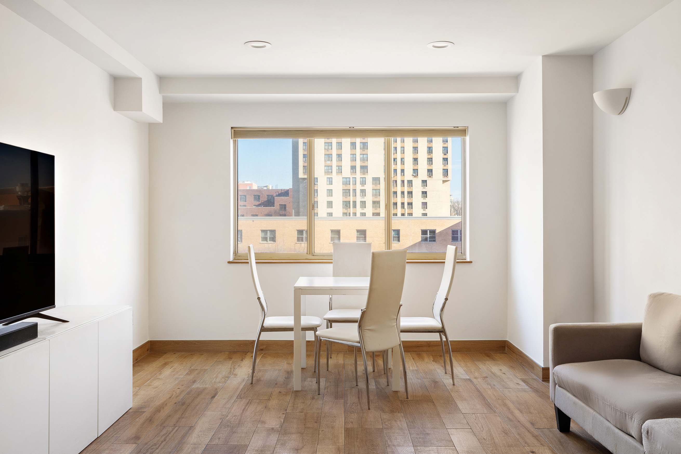 1400 5th Avenue, Unit 6P Manhattan, NY 10026 - Photo 2 of 8 a view of a livingroom with furniture and a window