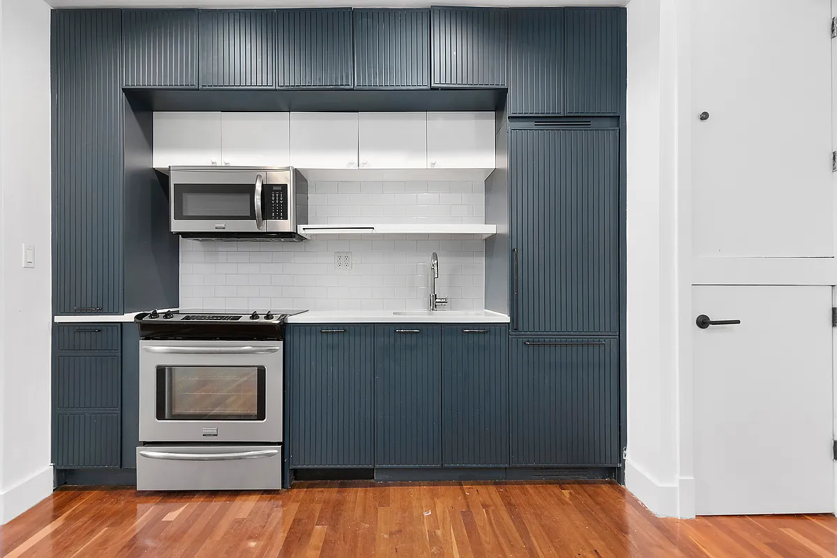 180 Bainbridge Street, Unit 211 Brooklyn, NY 11233 - Photo 3 of 21 a kitchen with stainless steel appliances a stove and a refrigerator