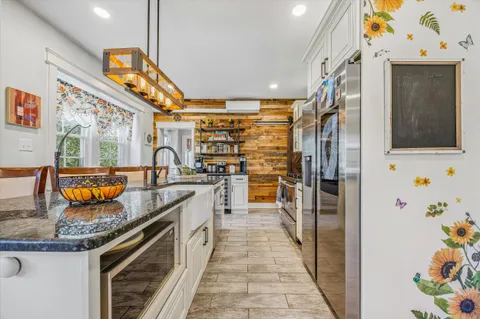 a kitchen with stainless steel appliances granite countertop a stove and a sink