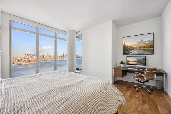 a bedroom with a bed and a desk