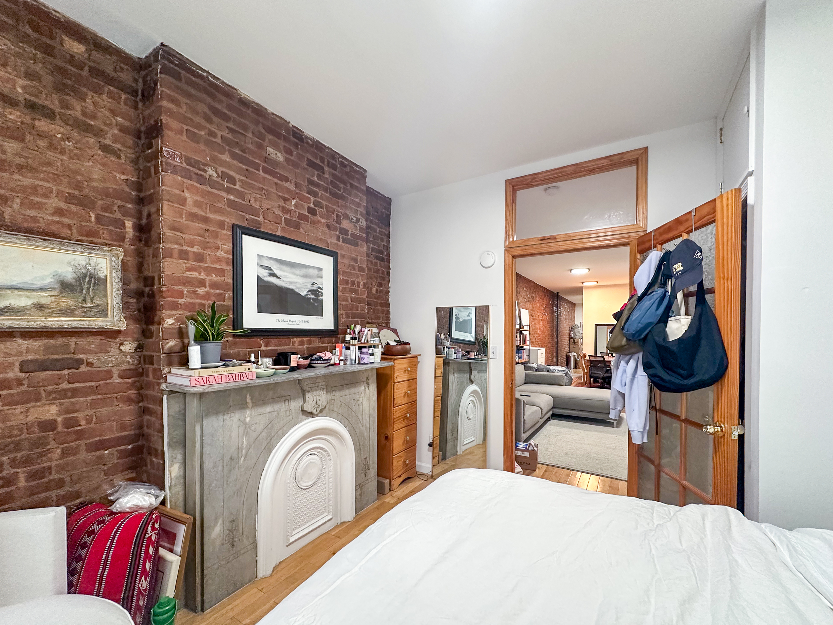 215 East 5th Street, Unit 7 Manhattan, NY 10003 - Photo 3 of 15 a bedroom with a bed and a flat screen tv