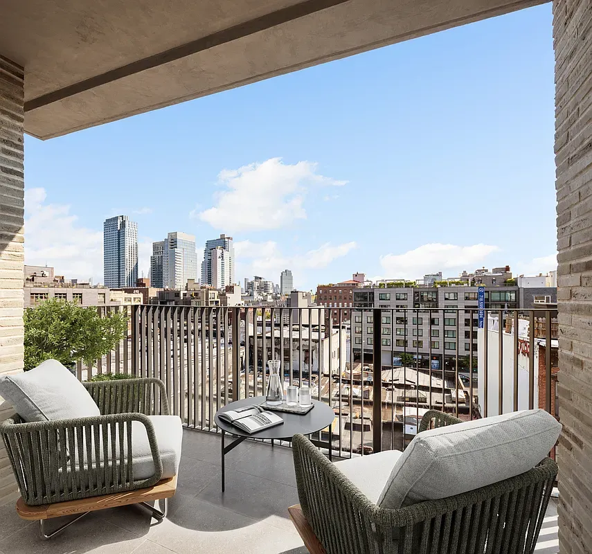 a balcony with a couch and city view