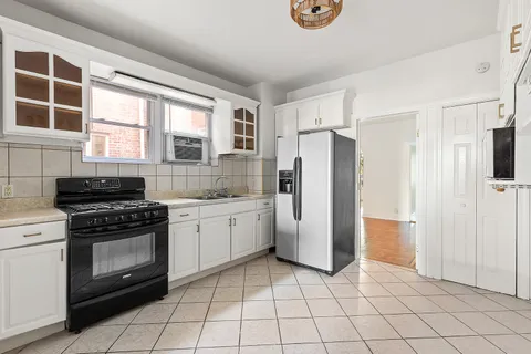 a kitchen with a stove a refrigerator and a sink