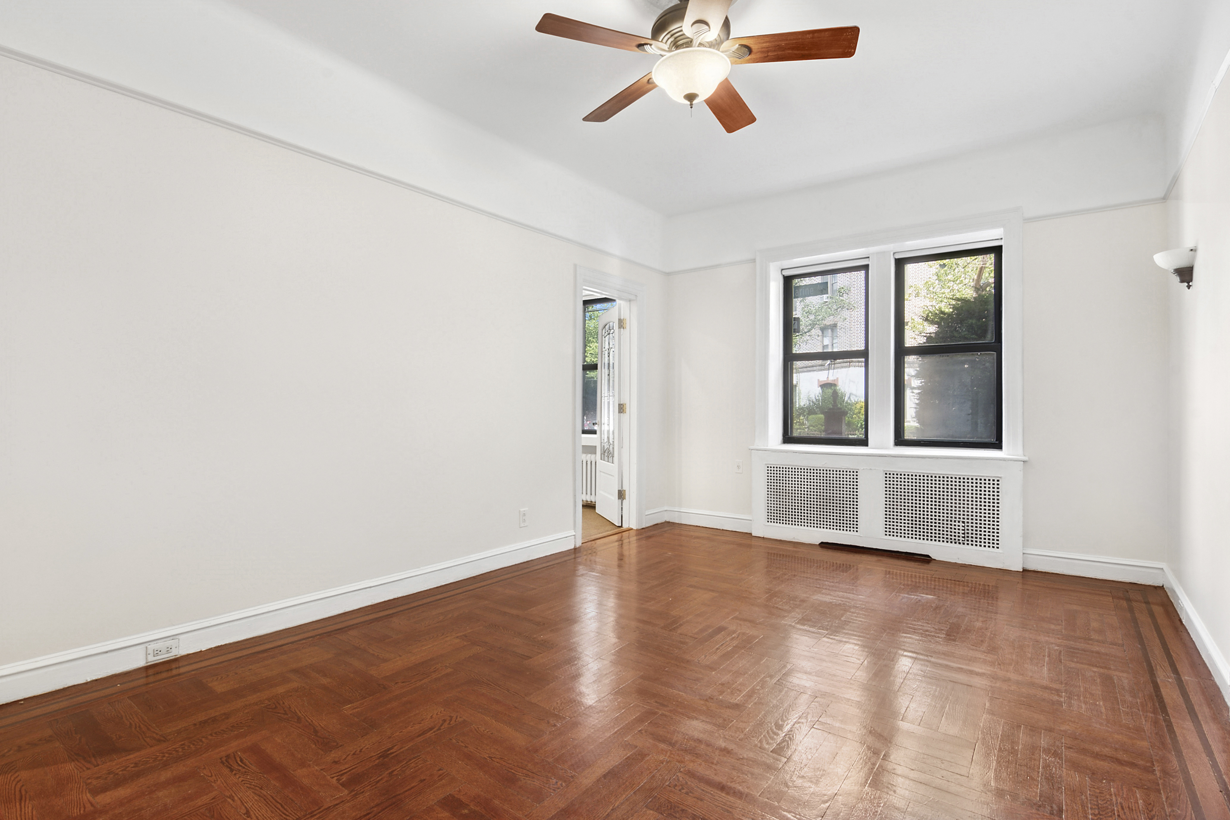2 Marine Avenue, Unit 1B Brooklyn, NY 11209 - Photo 4 of 14 an empty room with window and a ceiling fan