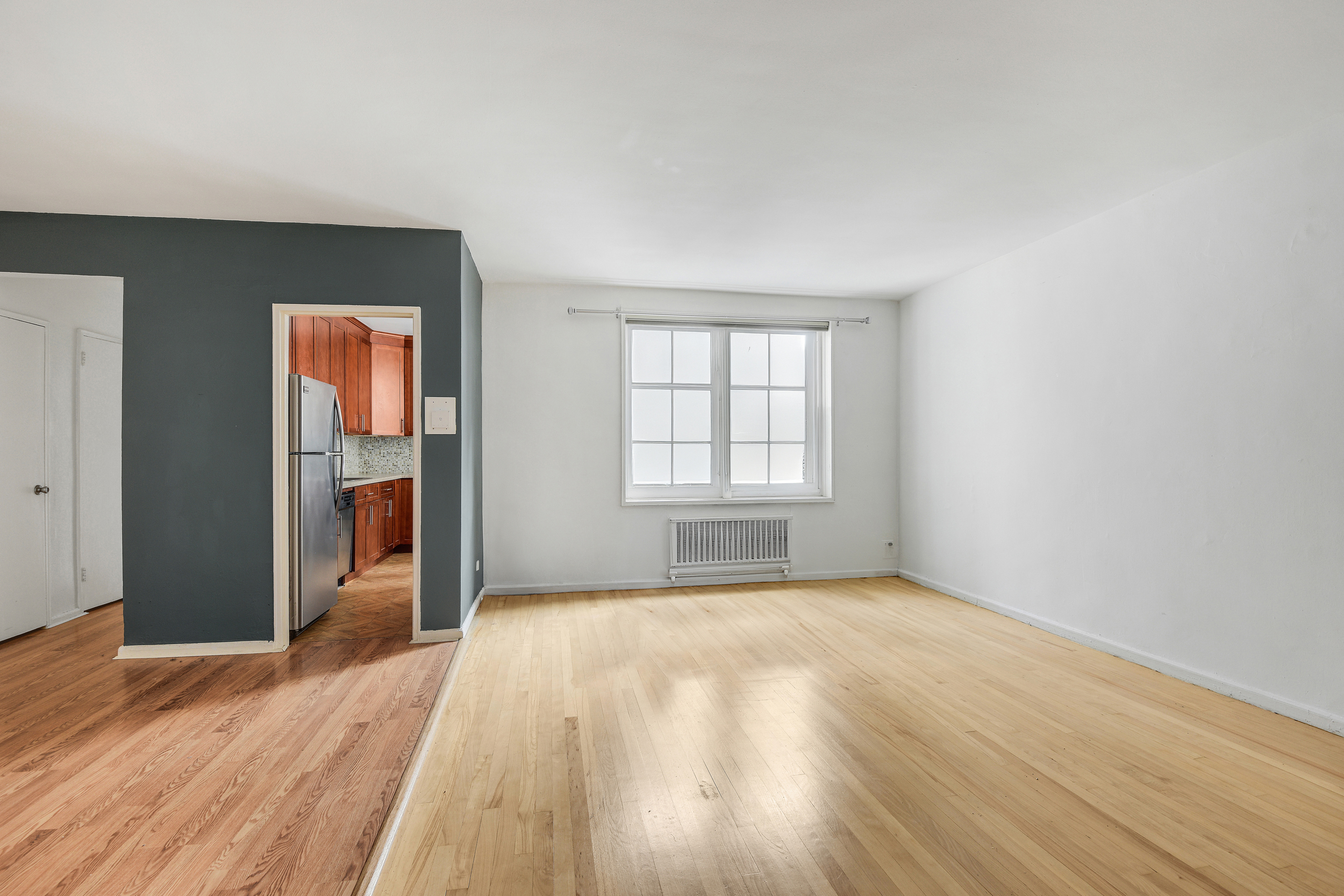 9801 Shore Road, Unit 4P Brooklyn, NY 11209 - Photo 2 of 13 an empty room with wooden floor closet and windows