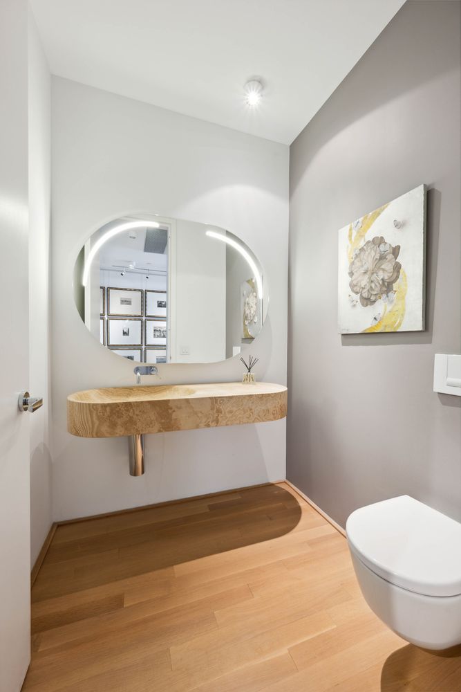 a bathroom with a sink mirror vanity and toilet
